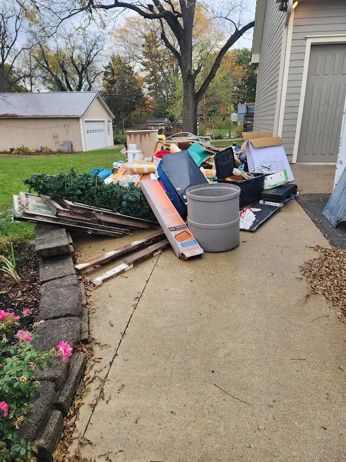 Dumpster being loaded with debris for Estate Cleanout Dumpster Rental in Midwest City